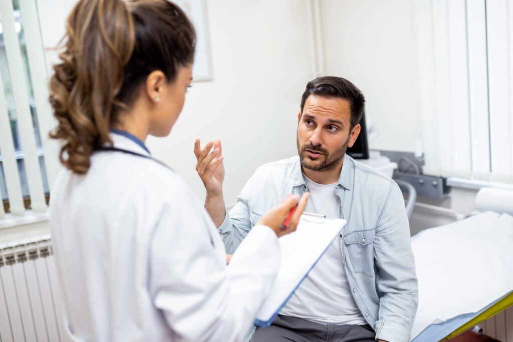 A man talks to his doctor about prescription drug addiction treatment in Itasca, IL.